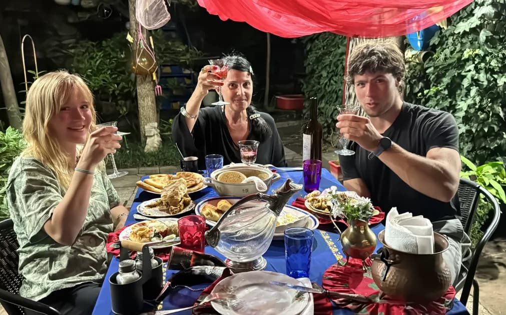 SecreTable guests participating in an authentic Georgian supra feast in Tbilisi, sharing traditional food, wine and toasts with a local host.